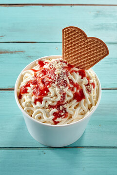 German vanilla ice cream spaghetti noodles and berry sauce