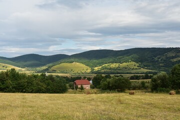 Beautiful landscape with trees and houses, in Trascau mountains, Transylvania, Romania.