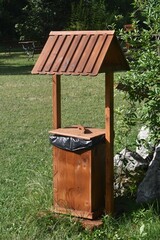 Wooden trash can, in the garden.
