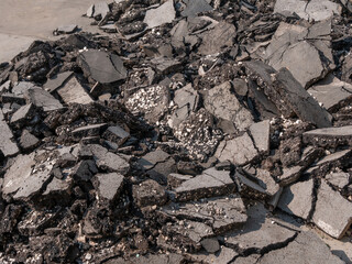 A pile of broken asphalt from the old road. Close-up.