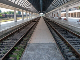 Fototapeta na wymiar Empty train station. A platform under a glass roof.