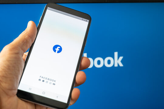 California, United States. Aug 08, 2021: Phone showing facebook app on the screen. Facebook is a photo and video sharing social media desktop background