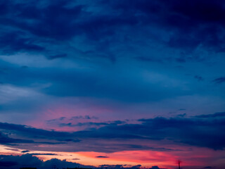 Panorama evening sky with blue, white and orange clouds.