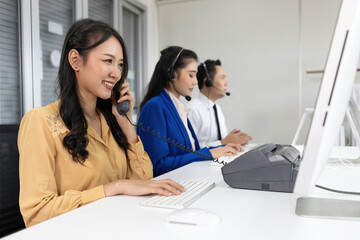 woman operator pick up telephone and talking with customer at call center service