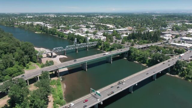 Aerial: Freeway bridges crossing the Willamette River, Salem, Oregon, USA