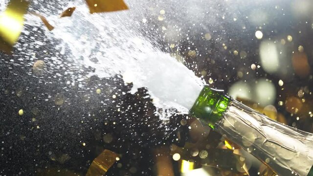 Super slow motion of Champagne explosion, opening champagne bottle closeup. Filmed on high speed cinema camera, 1000fps