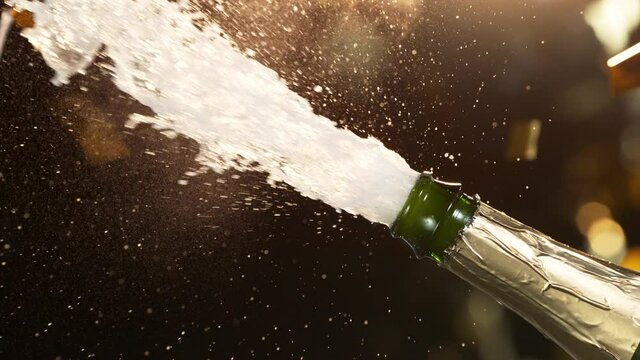 Super slow motion of Champagne explosion, opening champagne bottle closeup. Filmed on high speed cinema camera, 1000fps