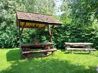 Naklejka premium Wooden tables with benches in the garden.