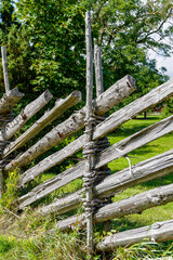 traditional wooden fence made with rough logs and boards in the Scandinavian style