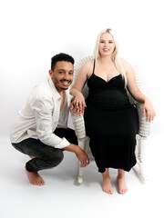 Stylish and happy multi-ethnic couple expecting a baby