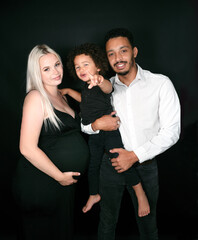 Stylish and happy multi-ethnic family expecting a baby