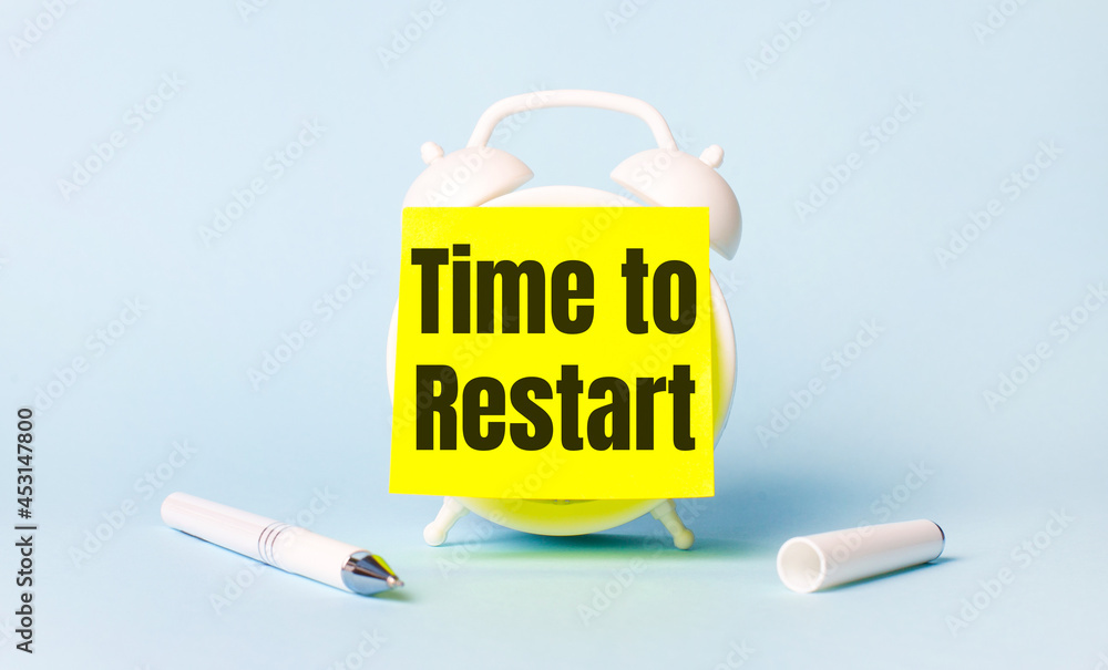 Poster on a light blue background - a white handle and an alarm clock with a bright yellow sticker glued to