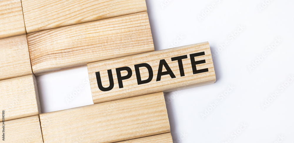 Poster on a light background, wooden blocks with the text update. close-up top view.