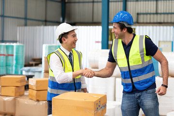 factory workers or engineers shaking hands together having agreement in warehouse storage