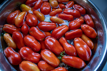 Whole Roma Tomatoes in Bowl with water