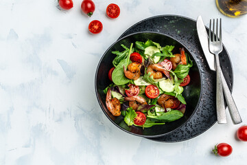 Dietary menu. Healthy vegan salad of smoked shrimps, cherry tomatoes, cucumber and mixed leaves. Healthy eating concept. Detox diet. Vegetarian lunch. Weight loss, top view