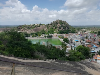 Fototapeta na wymiar hills with pond under the sky from famous tourist destination Shravanbelagola Karnataka