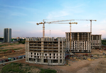 Tower crane on construction site during formwork. Arial view of the cranes the conctruct the high-rise building. Construction and the built environment. Pouring concrete into the formworks