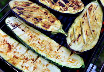 Eggplant on grilled. Cooking eggplants on hot charcoal and fire. Barbecue grill vegetables on flames.