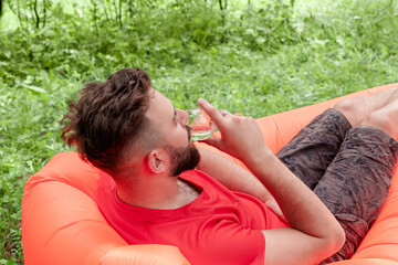 Portrait of young man With glass drinking wine. Summer Relax