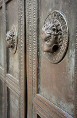 lion head knocker on old church door, cathedral in Aachen Germany. Vintage door style. Symbolic ornament historic decoration. 
