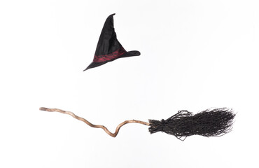 black broom and witch hat isolated on white background