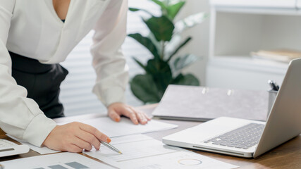 Business Professional Accountant Woman working on laptop computer making research for planning startup at desktop working process in office