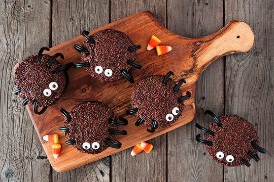 Halloween Spider Cupcakes, Above View On A Wooden Serving Platter Over A Dark Wood Background