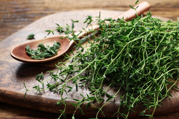 Bunch of aromatic thyme on wooden table, closeup