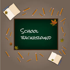 Green board in the school classroom with pencils and books
