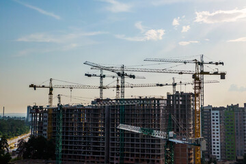 Crane and construction site at sunset. housing estate development. general view.