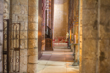 beautiful candle light in ancient Roman church side-aisle