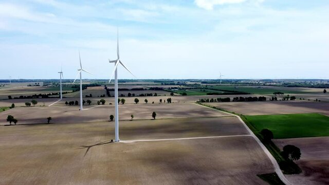 Renewable energy being generated by wind turbines on farmland creating sustainable electricity