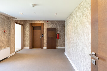 Interior of a carpeted hotel corridor doorway