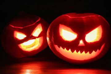 Halloween pumpkin on a dark old wooden background. Jack's lanterns with burning candles
