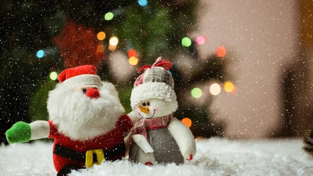 Snow falling over santa claus and snowman against spots of light