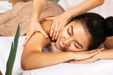 Fototapeta na wymiar Thai Massage therapy. Portrait asian woman enjoying massage at the spa