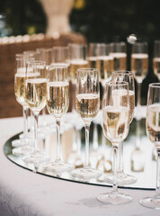 glasses with champagne on the table outdoors, wedding buffet