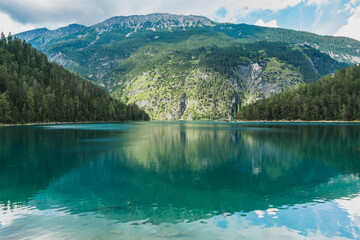 a beautiful view to a mountain and Blindsee lake with it's emerald green water