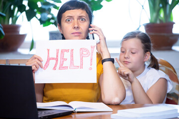 Mother working from home with kid. Children make noise and disturb woman at work.