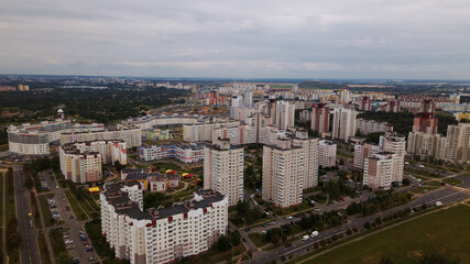 City block. Modern multi-storey buildings. Flying at dusk at sunset. Aerial photography.