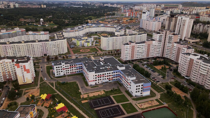 City block. Modern multi-storey buildings. Flying at dusk at sunset. Aerial photography.