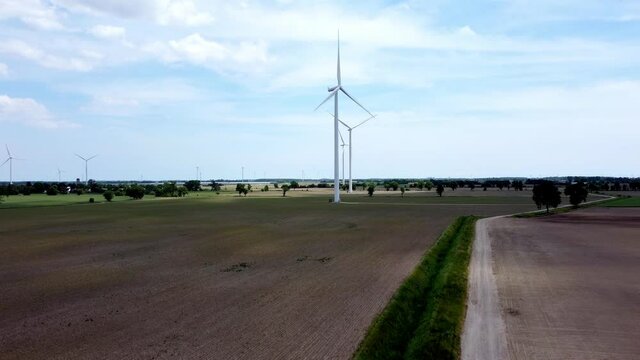 Renewable energy being generated by wind turbines on farmland creating sustainable electricity