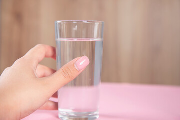 woman holding glass of water