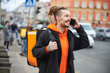 Handsome young courier doing express food transferring