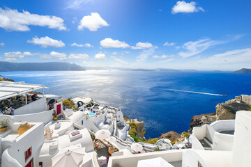 The whitewashed hillside town of Oia, Greece, filled with cafes and hotels overlooking the Aegean...