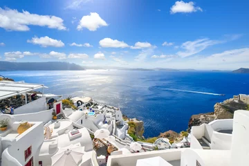 Foto op Canvas The whitewashed hillside town of Oia, Greece, filled with cafes and hotels overlooking the Aegean Sea and Caldera. © Kirk Fisher