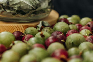 Green and red gooseberries. Gooseberries on a wooden surface