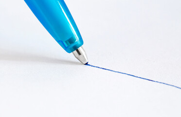 Ballpoint pen, drawing line in blue ink on white paper, close-up view
