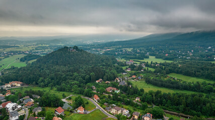 Obraz premium Aerial drone view, small typical polish villagesurrounded by beautiful mountains at summer.